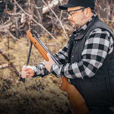 Beeman R9 break barrel air rifle cocked by shooter
